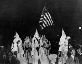 <p>Ku Klux Klan members ride in a parade through the streets of Tulsa, Okla., on Sept. 21, 1923. (Photo: AP) </p>