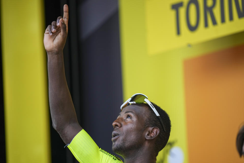 Stage winner Eritrea's Biniam Girmay celebrates on the podium after the third stage of the Tour de France cycling race over 230.8 kilometers (143.4 miles) with start in Piacenza and finish in Turin, Italy, Monday, July 1, 2024. (AP Photo/Daniel Cole)