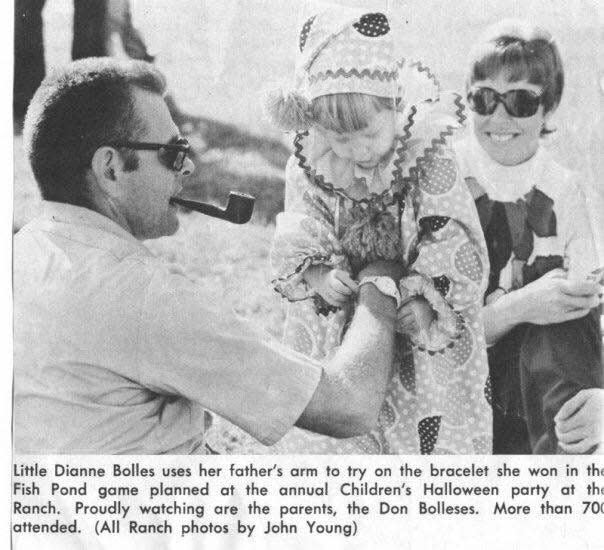 Diane Bolles tries on a bracelet she won at a Halloween party at the Republic and Gazette Ranch. Diane is the daughter of Republic reporter Don Bolles and Rosalie Bolles.