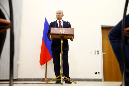 Russian President Vladimir Putin attends a press conference at Tegel airport after a meeting with German Chancellor Angela Merkel in Berlin, Germany, October 20, 2016. REUTERS/Axel Schmidt