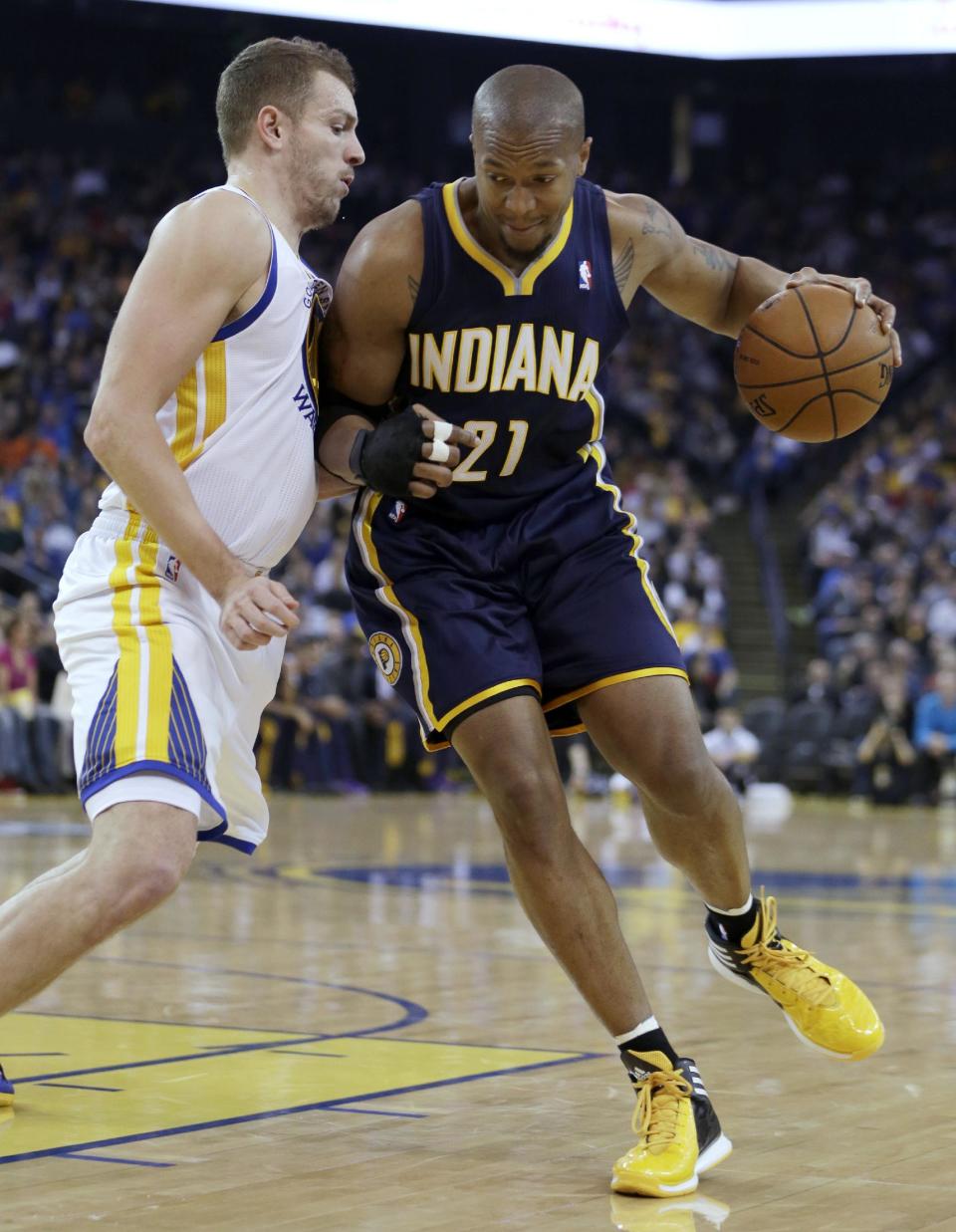 Indiana Pacers' David West, right, drives the ball past Golden State Warriors' David Lee during the first half of an NBA basketball game, Monday, Jan. 20, 2014, in Oakland, Calif. (AP Photo/Ben Margot)