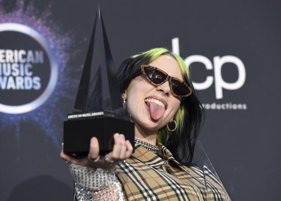 Billie Eilish poses in the press room with the award for new artist of the year and favorite alternative rock artist at the American Music Awards on Sunday, Nov. 24, 2019, at the Microsoft Theater in Los Angeles. (Photo by Jordan Strauss/Invision/AP)