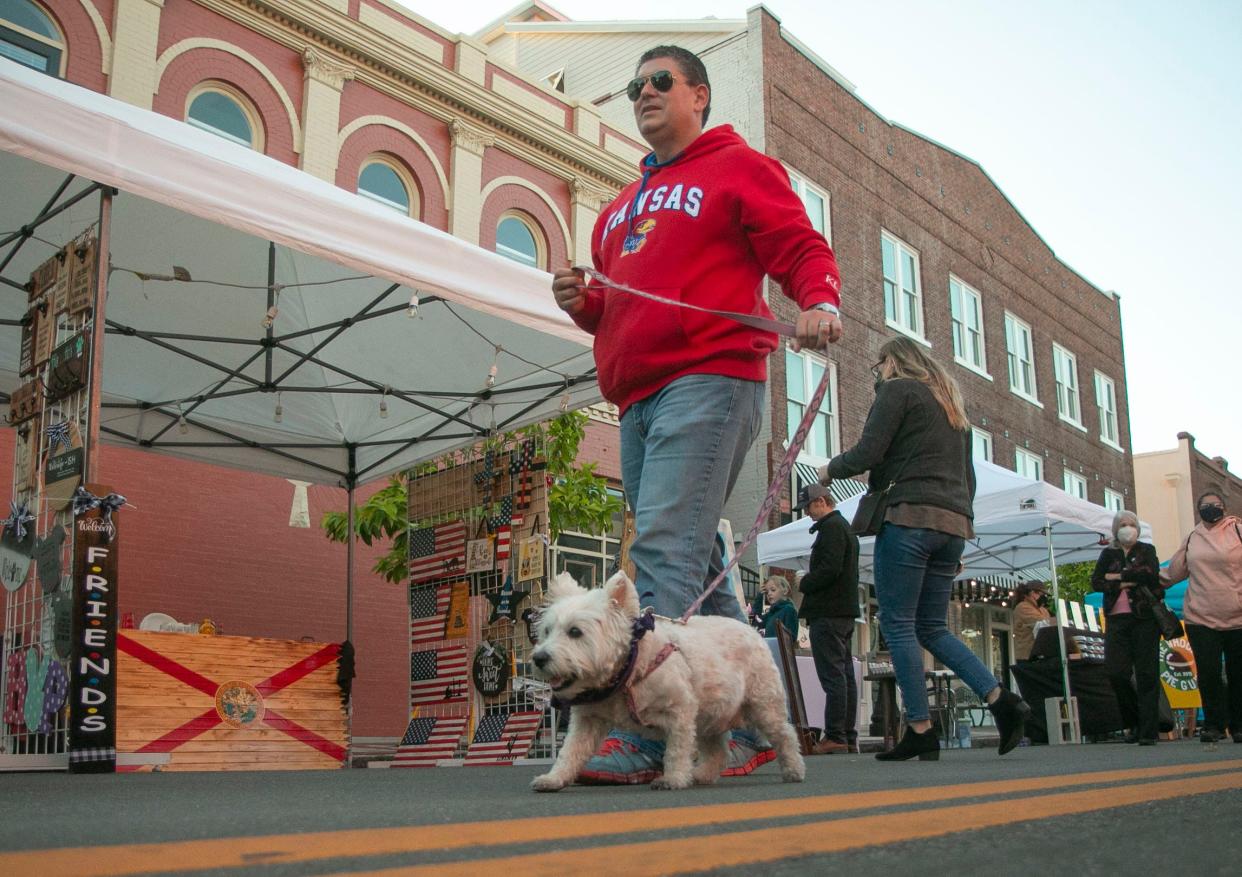 Lakeland resident Marshall Gross walks "Molly," his  West Highland White Terrier along North Kentucky Avenue during a previous First Friday.