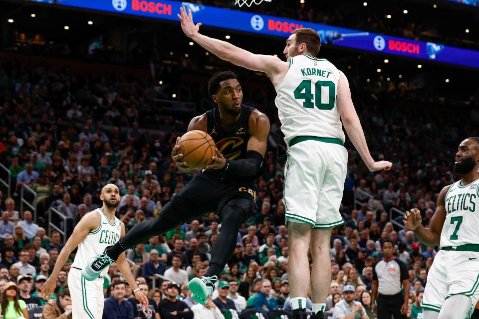 Cleveland Cavaliers guard Donovan Mitchell (45) goes around Boston Celtics center Luke Kornet (40) looking to pass Tuesday in Boston.