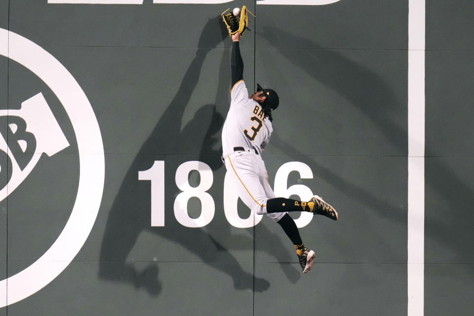 Pittsburgh Pirates center fielder Ji Hwan Bae leaps high and makes the catch against the wall on a fly out by Boston Red Sox's Rafael Devers during the eighth inning of a baseball game at Fenway Park, Tuesday, April 4, 2023, in Boston. (AP Photo/Charles Krupa)