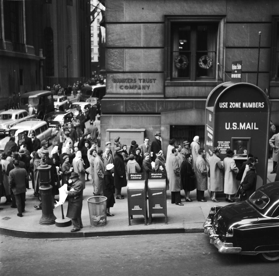 People lined up on&nbsp;Wall Street in New York City to post their Christmas cards and packages at a huge mailbox.