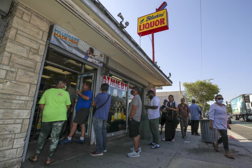 Hawthorne, CA - July 29: People stand in line to purchase tickets for Mega Millions lottery as jackpot tops $1 billion at Bluebird Liquor on Friday, July 29, 2022 in Hawthorne, CA. (Irfan Khan / Los Angeles Times)