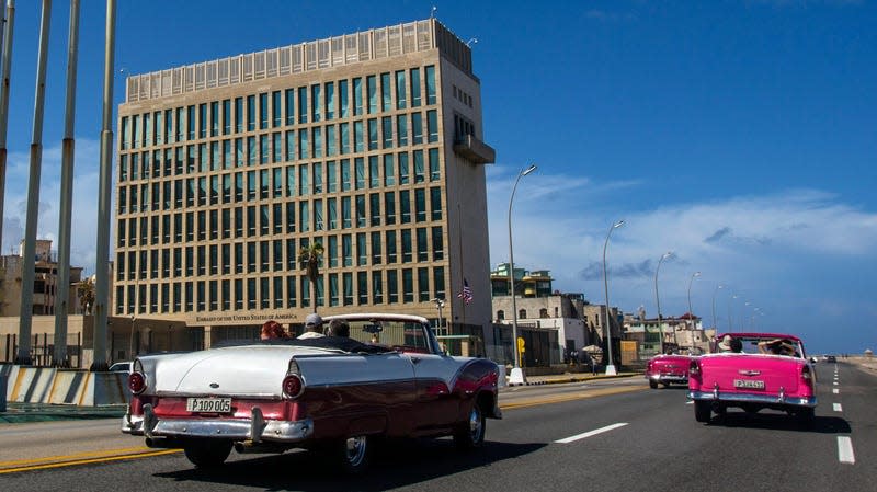 Tourists ride classic convertible cars on the Malecon beside the U.S. Embassy in Havana, Cuba, on Oct. 3, 2017. 