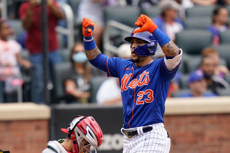 Javier Baez gestures with his thumbs down at home plate after his two-run home run on Sunday.