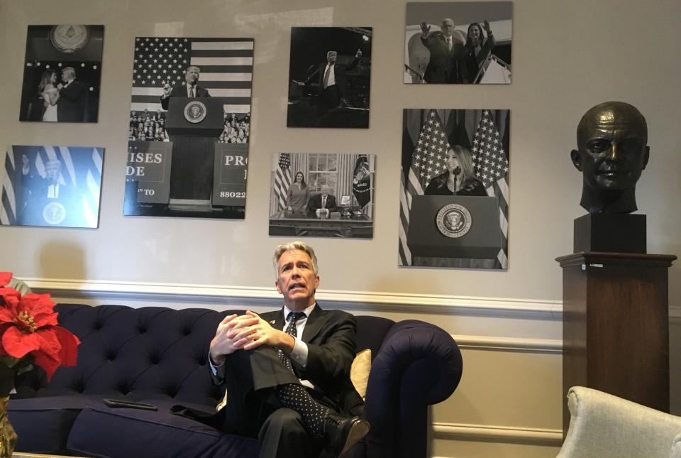 Walsh waits in vain to visit top RNC officials beneath a wall of photos devoted to President Donald Trump. (Photo: S.V. Date/HuffPost)