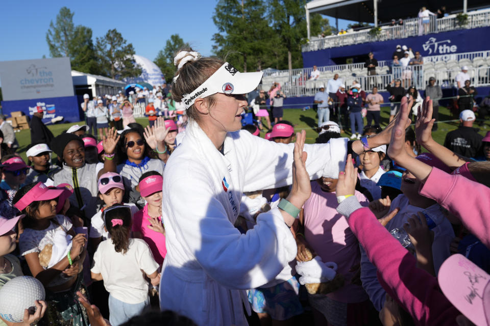 Nelly Korda high-fives young fans while celebrating her win at the Chevron Championship LPGA golf tournament Sunday, April 21, 2024, at The Club at Carlton Woods in The Woodlands, Texas. (AP Photo/Eric Gay)