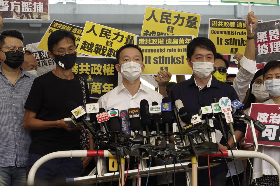 Pro-democracy lawmakers, from second left to right; Eddie Chu, Raymond Chan and Ted Hui speak outside a local court in Hong Kong Thursday, Nov. 19, 2020. Three former pro-democracy lawmakers appeared in court Thursday, one day after they were arrested for disrupting the legislature during debate on a national anthem bill earlier this year. (AP Photo/Vincent Yu)