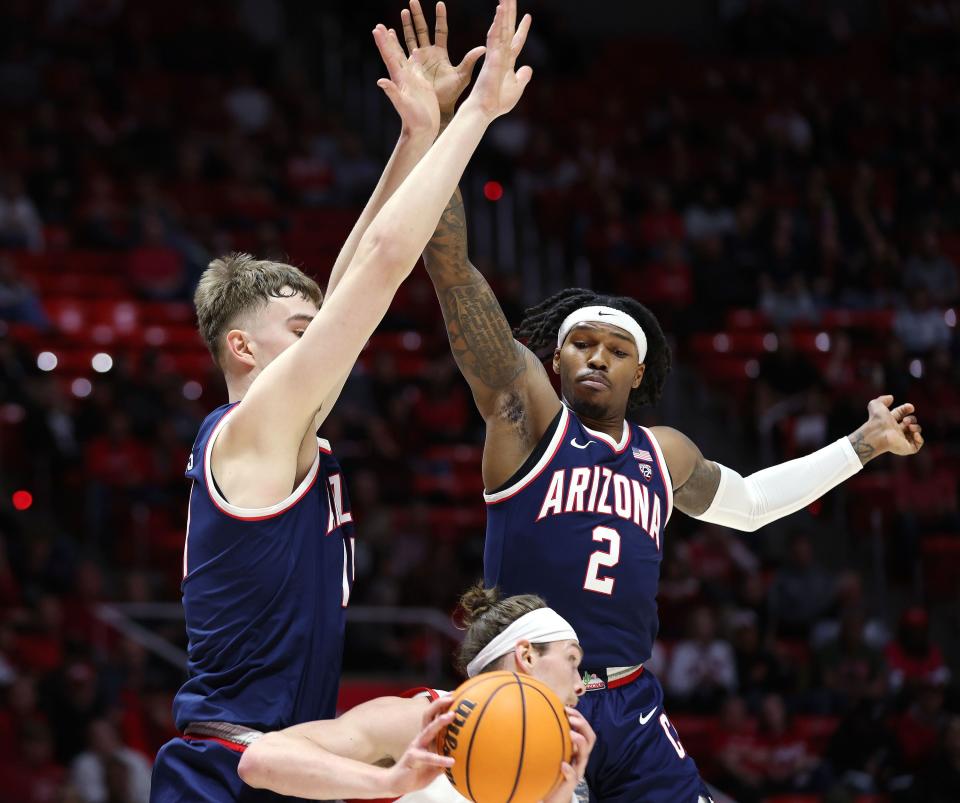 Utah Utes guard Gabe Madsen (55) is defended by Arizona Wildcats guard Caleb Love (2) in Salt Lake City on Thursday, Feb. 8, 2024. | Jeffrey D. Allred, Deseret News