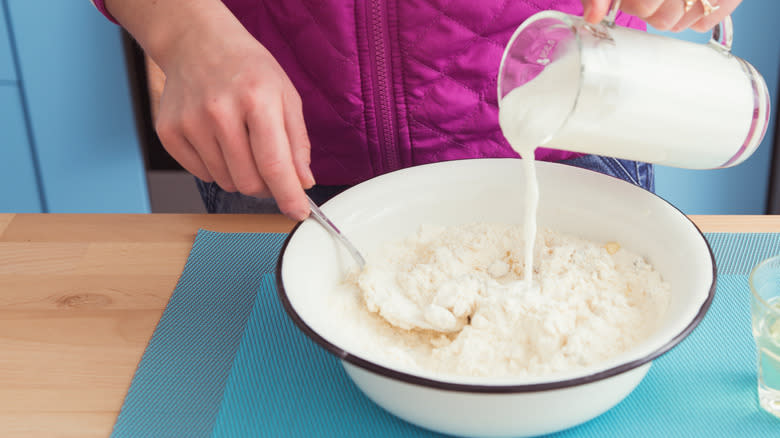 pouring buttermilk into flour