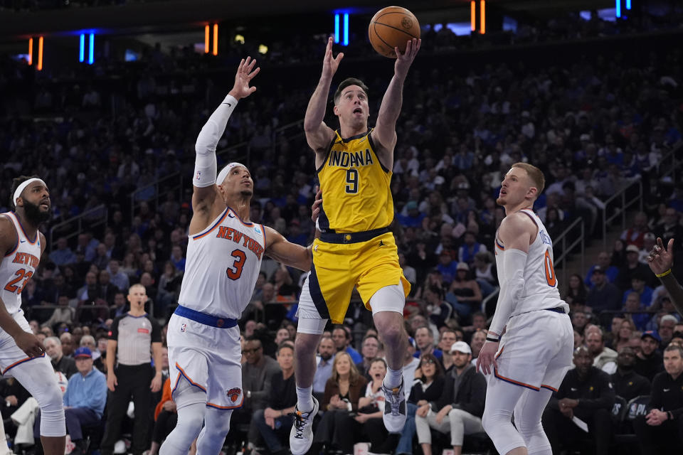 Indiana Pacers' T.J. McConnell (9) drives past New York Knicks' Josh Hart (3) and Donte DiVincenzo (0) during the second half of Game 1 in an NBA basketball second-round playoff series Monday, May 6, 2024, in New York. (AP Photo/Frank Franklin II)