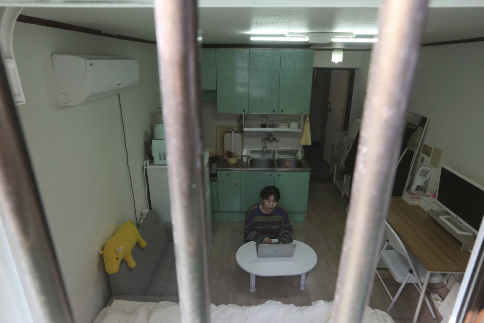 Kim Da-hye, a 29-year-old South Korean, sits with her laptop computer in her semi-basement apartment in Seoul, South Korea, Saturday, Feb. 15, 2020. For many South Koreans, the image of a cramped basement apartment portrayed in the Oscar-winning film “Parasite” rings true, bringing differences in their social status to worldwide attention.(AP Photo/Ahn Young-joon)