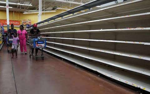 Empty shelves at a Walmart supermarket in Florida - Credit: CARLO ALLEGRI/Reuters