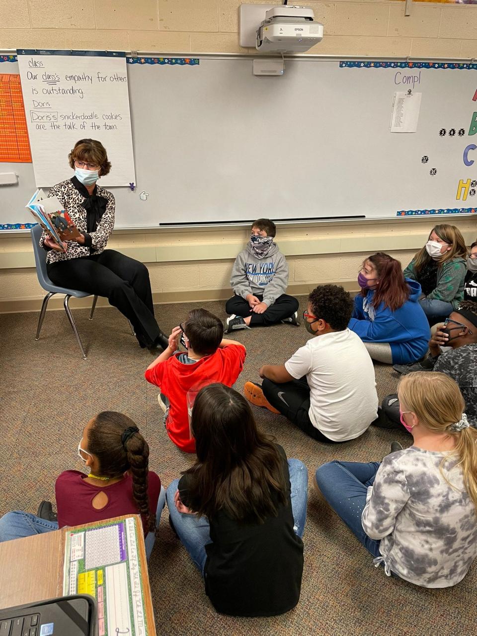 To prepare younger MCS students for incoming refugee families, MCS Director of Public Education and CEO Lee Ann Kwiatkowski reads the book "What is a Refugee?" to a fourth grade class at North View Elementary in 2021.