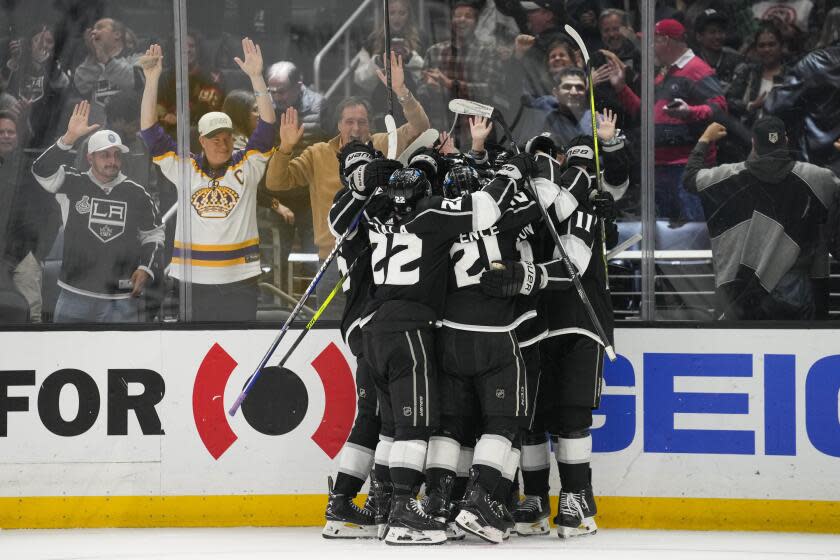 The Los Angeles Kings celebrate after right winger Adrian Kempe scores in overtime.