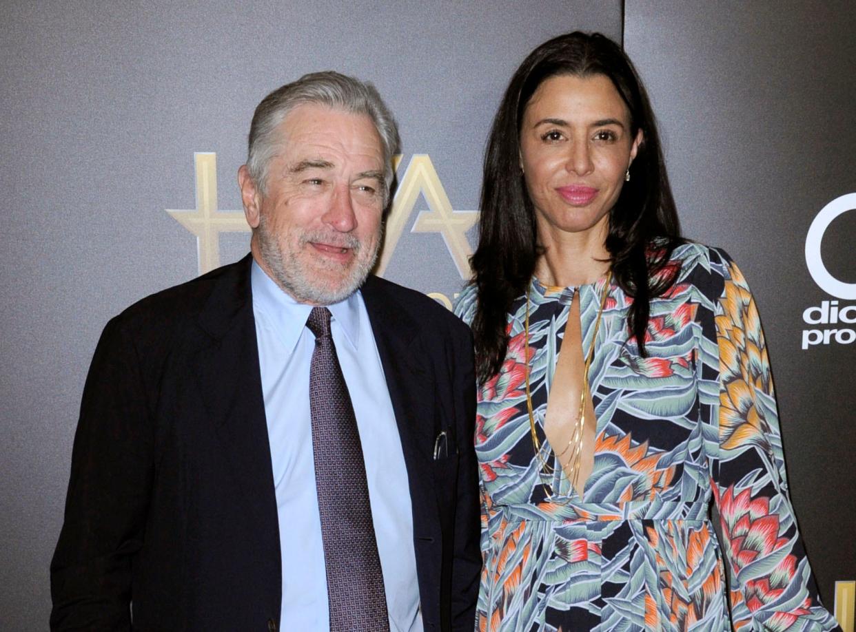 Robert De Niro posing for photographers with Drena De Niro on the red carpet.