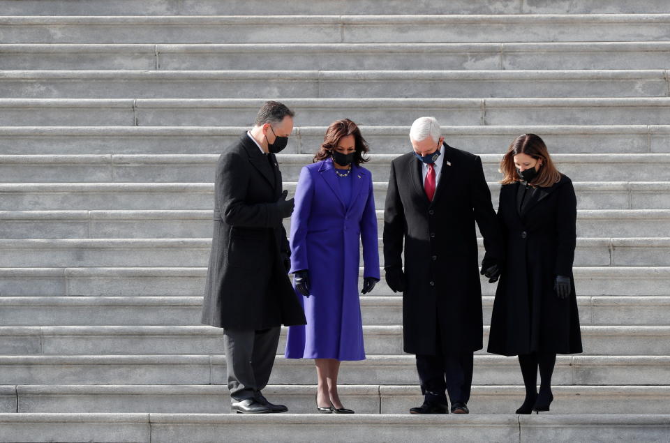 Former U.S. Vice President Mike Pence and his wife Karen and U.S. Vice President Kamala Harris and her husband Doug Emhoff walk down the stairs after the inauguration of Joe Biden as the 46th President of the United States, in Washington on January 20, 2021. (Mike Segar/Reuters)