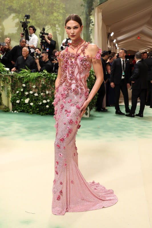 <p>Dia Dipasupil/Getty Images</p><p>The supermodel stepped out at the Met Gala in this pink floral number bejeweled with Swarovski crystals. </p>
