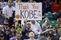 In this March 28, 2016, file photo, a fan holds a sign for Los Angeles Lakers forward Kobe Bryant during the second quarter of an NBA basketball game against the Utah Jazz, in Salt Lake City. Bryant, the 18-time NBA All-Star who won five championships and became one of the greatest basketball players of his generation during a 20-year career with the Los Angeles Lakers, died in a helicopter crash Sunday, Jan. 26, 2020. He was 41. (AP Photo/Rick Bowmer, File)