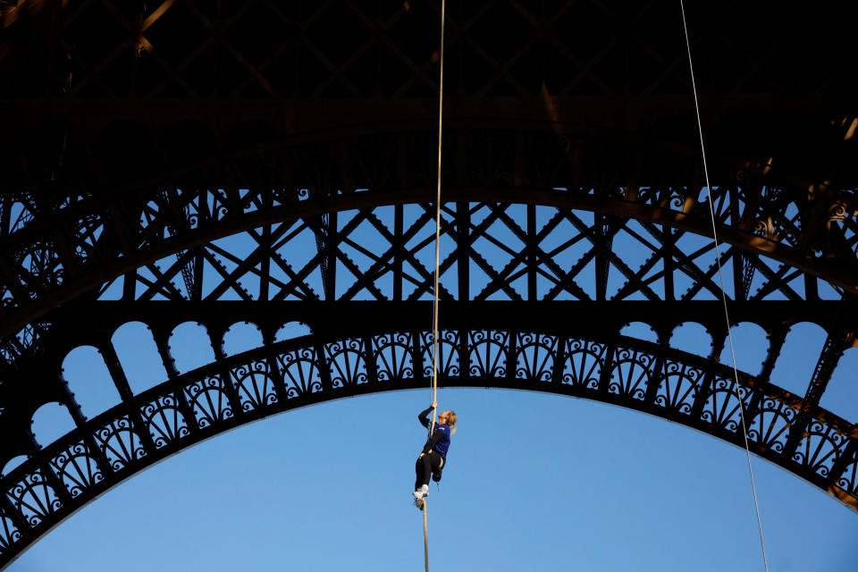 Athlete and Olympics torch bearer Anouk Garnier climbs a 110-meter-long rope launched in the center of the Eiffel Tower square to reach the 2nd floor and to attempt to break the world record for rope climbing, in Paris, France, April 10, 2024. / Credit: Sarah Meyssonnier / REUTERS