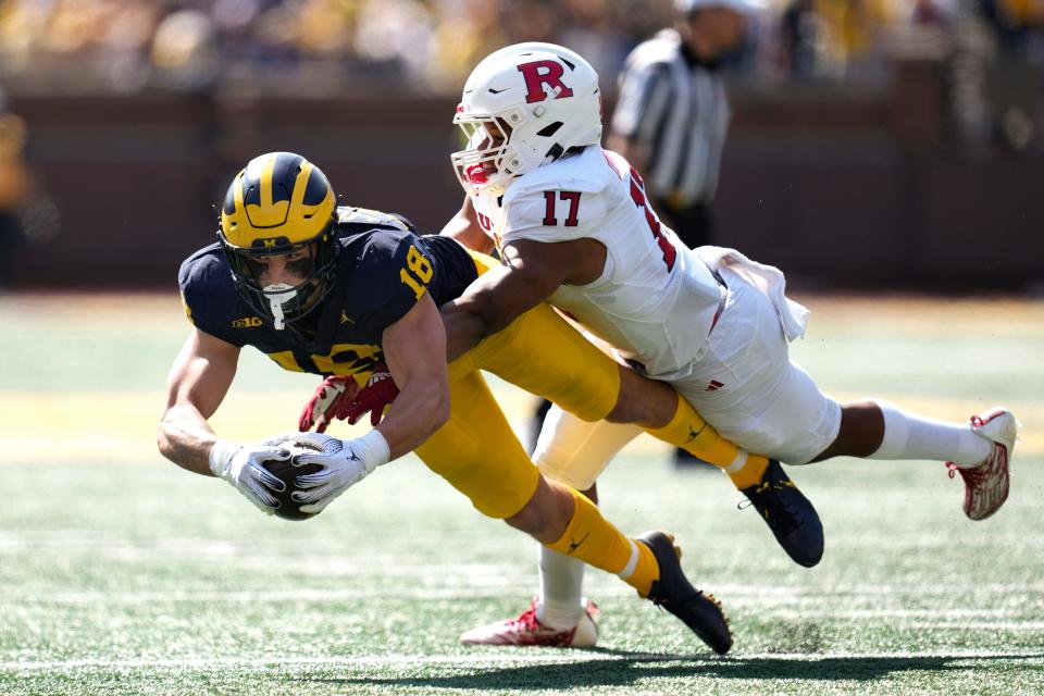 Michigan tight end Colston Loveland (18) reaches for yardage after a catch as Rutgers linebacker Deion Jennings (17) defends in the first half in Ann Arbor, Saturday, Sept. 23, 2023.