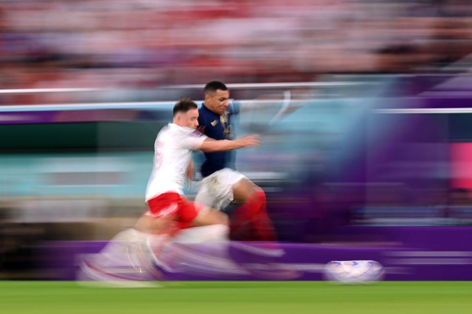 Mbappe in full flight against Poland’s Matty Cash (Getty Images)