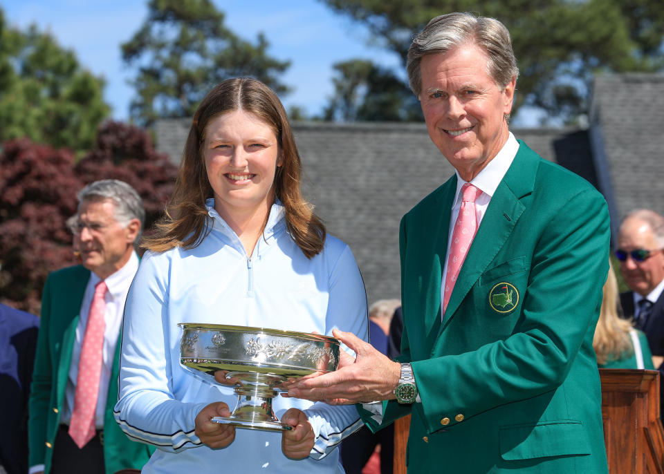AUGUSTA, GEORGIA - APRIL 06: Lottie Woad of England is presented with the trophy by Fred Ridley The Chairman of The Augusta National Golf Club after her one-shot win in the final round of the Augusta National Women's Amateur at Augusta National Golf Club on April 06, 2024 in Augusta, Georgia. (Photo by David Cannon/Getty Images)