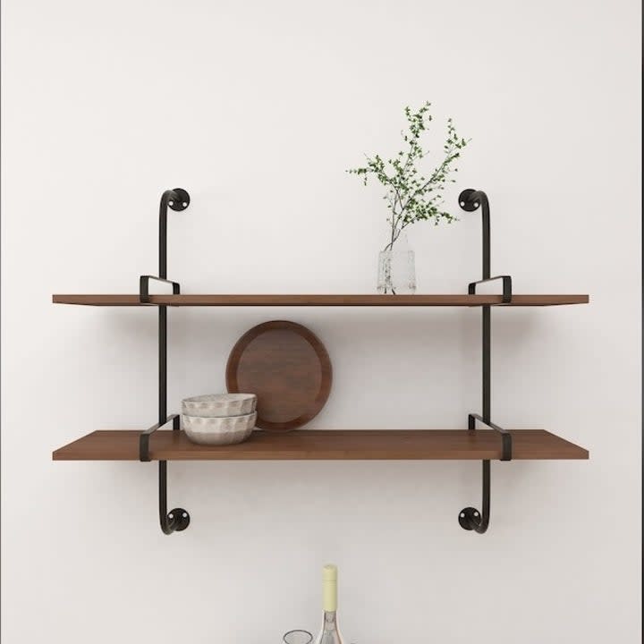 the floating shelves with brackets hanging on a wall