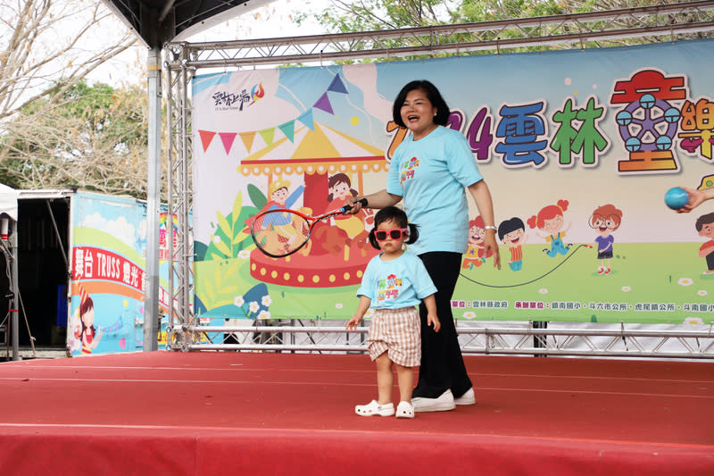 雲林農博公園成遊樂場  張麗善帶孫女走秀 歡慶兒童節，雲林縣政府今年匯聚小朋友最愛的遊樂 設備、美食市集與大型玩偶，31日將農博公園變身大 型遊樂園，縣長張麗善（後）也帶著孫女（前）走 秀，與大家同歡。  中央社記者姜宜菁攝  113年3月31日 