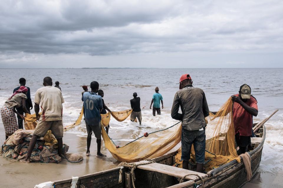 Fishermen haul their nets by hand from the beach in Muanda, Democratic Republic of Congo. Unregulated fishing by foreign trawlers and other factors have depleted fishing stocks and impoverished local fishermen. <a href="https://www.gettyimages.com/detail/news-photo/fishermen-haul-their-nets-by-hand-from-the-beach-in-muanda-news-photo/1237283044" rel="nofollow noopener" target="_blank" data-ylk="slk:Alexis Huguet/AFP via Getty Images;elm:context_link;itc:0;sec:content-canvas" class="link ">Alexis Huguet/AFP via Getty Images</a>