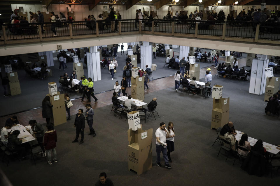 Voters line up at a polling stations during regional and local elections, in Bogota, Colombia, Sunday, Oct. 29, 2023. (AP Photo/Ivan Valencia)