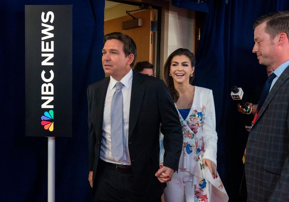 Gov. Ron DeSantis enters the spin room with his wife Casey after the Republican National Committee presidential primary debate in Miami.