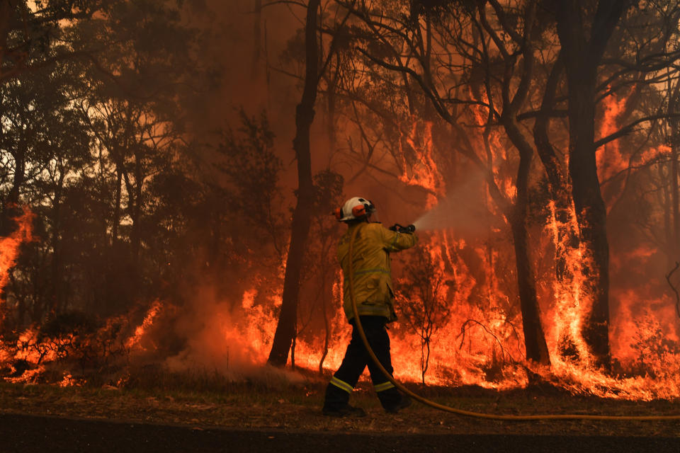 CENTRAL COAST, AUSTRALIA - DECEMBER 10: Rural Fire Service (RFS) firefighters fight a flare up on a containment line at the Three Mile Fire in the suburb of Kulnura on December 10, 2019 on the Central Coast, Australia. More than 80 bushfires are burning across New South Wales, and thousands of firefighters and aircraft on alert as temperatures are expected to soar above 40c. (Photo by Sam Mooy/Getty Images)