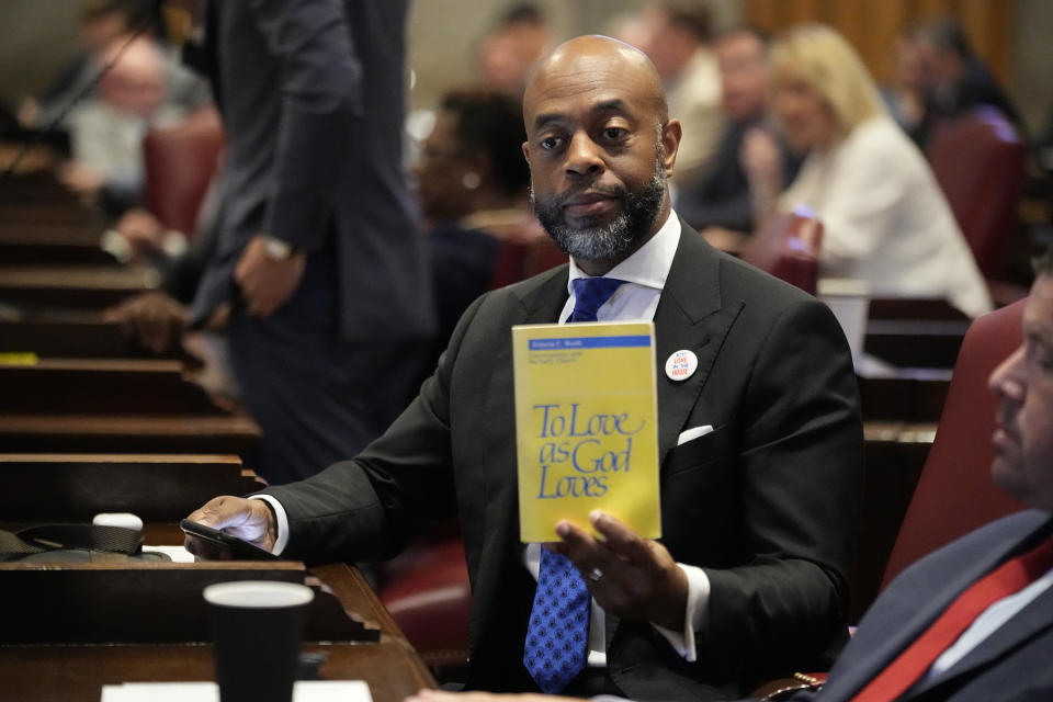 Rep. Harold Love, D-Nashville, holds a book on the House floor during a special session of the state legislature on public safetyTuesday, Aug. 22, 2023, in Nashville, Tenn. (AP Photo/George Walker IV)