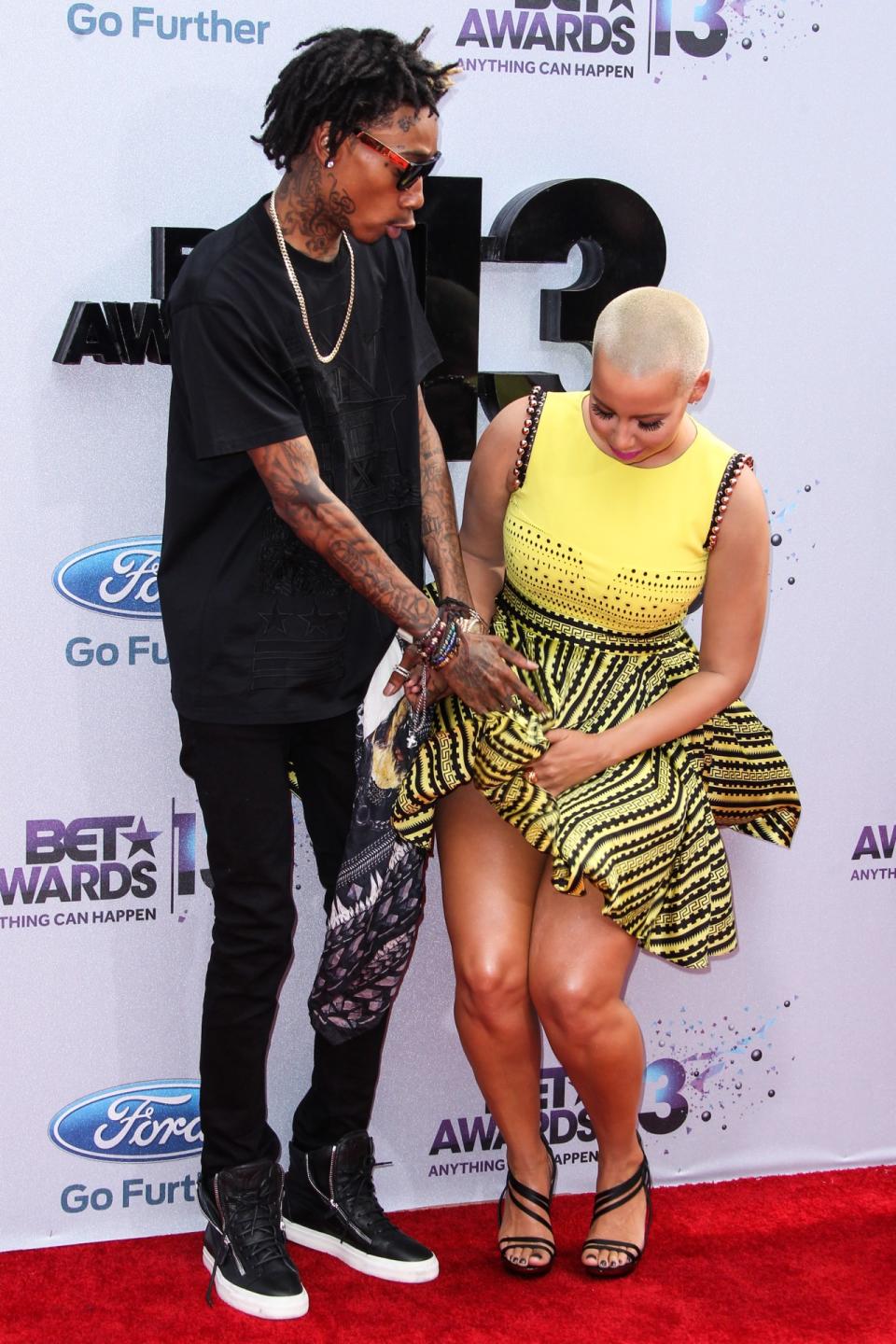 Ever the lover of her rear, Amber Rose flashed her backside while on the red carpet at the 2013 BET Awards alongside Wiz Khalifa.