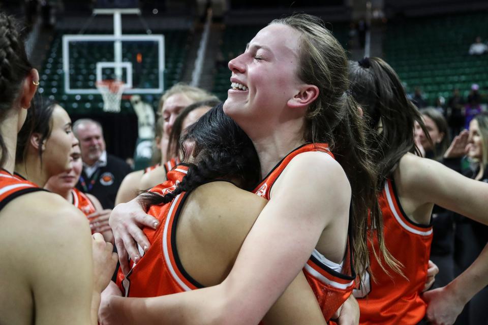 Rockford guard Anna Wypych (2) is congratulated by teammates and coaches as they celebrate 40-36 win over West Bloomfield in the MHSAA Division 1 girls basketball final at Breslin Center in East Lansing on Saturday, March 18, 2023.