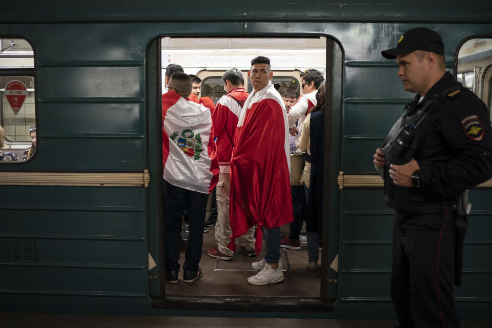 <p>Soccer fans ride in the metro near the Luzhniki stadium before the group A match between Russia and Saudi Arabia which opens the 2018 soccer World Cup in Moscow, Russia, Thursday, June 14, 2018. (AP Photo/Felipe Dana) </p>