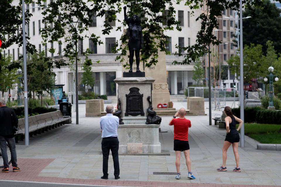 People admired the new unofficial black resin and steel statue this morning (AP)