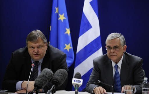 Greek Finance Minister Evangelos Venizelos (left) and Greek Prime Ministers Lucas Papademaos give a joint press after their Eurogroup Council meeting at EU headquarters in Brussels. A huge eurozone rescue package agreed saves Greece from default, keeps it in the single currency bloc under strict controls but markets are sceptical and Greek unions are calling fresh protests