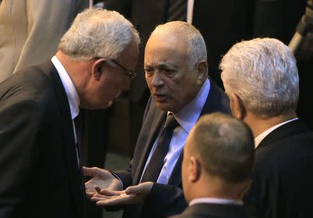 Palestinian Foreign Minister Riyad al-Malki (L) talks to Arab League Secretary General Nabil Elaraby (C) during an emergency meeting at the League's headquarters in Cairo March 9, 2015. REUTERS/Mohamed Abd El Ghany