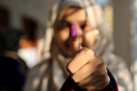 A woman displays her inked thumb after casting her vote for the general election in Dhaka, Bangladesh, December 30, 2018. REUTERS/Mohammad Ponir Hossain