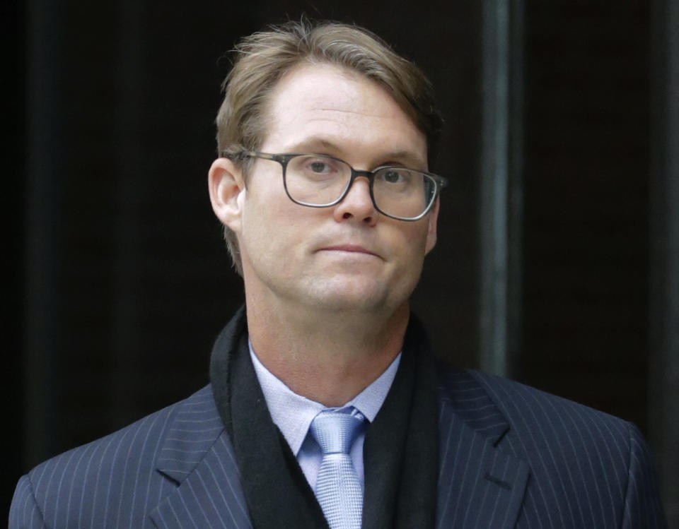 Mark Riddell departs federal court Friday, April 12, 2019, in Boston, after pleading guilty to charges in a nationwide college admissions bribery scandal. (AP Photo/Charles Krupa)