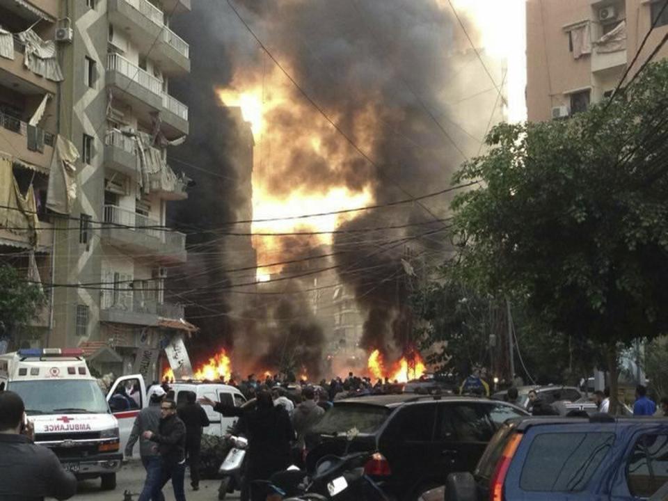 Fire and smoke is seen at the site of an explosion in Beirut's southern suburbs January 2, 2014. The powerful explosion struck southern Beirut on Thursday, a stronghold of the Shi'ite group Hezbollah, killing at least two people and sending a column of smoke into the sky, a witness said. (REUTERS/Jamal Sahili)