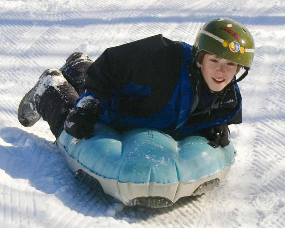 FILE - This Dec. 21, 2005 file photo shows Garrett Marsh, 12, airboarding down the slope near Snowmass Village, Colo. Visitors to winter recreation destinations enjoy activities like airboarding, snowkiting and skijoring as alternatives to more traditional snow sports such as skiing or snowboarding. (AP Photo/Paul Conrad, file)