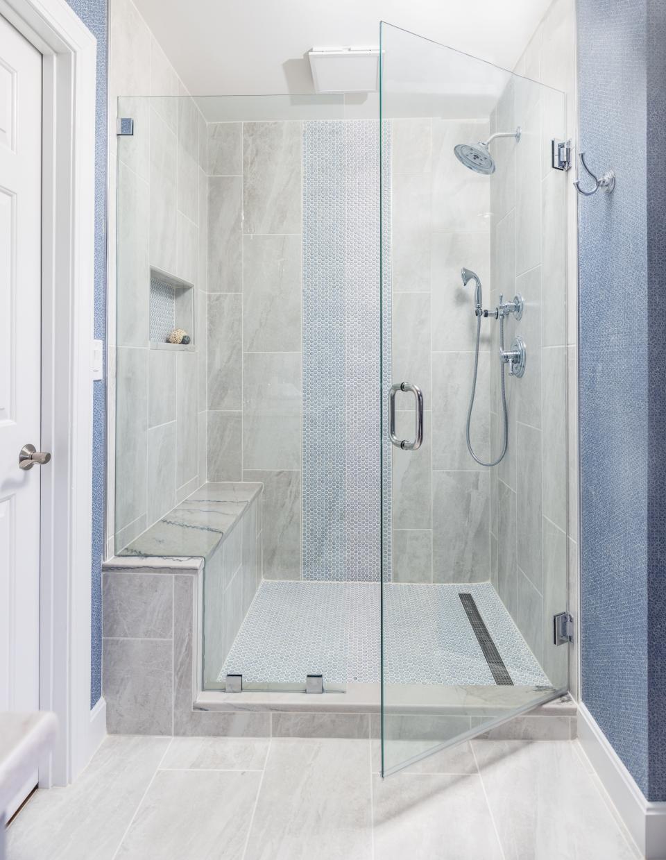 The new, larger shower boasts a built-in shelf as well as a bench seat.