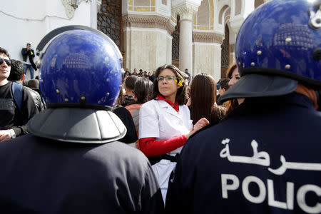 Riot police stand guard in front of Algerian doctors, who are completing their residency stage of their studies, holding a sit-in protest in Algiers Algeria , February 12, 2018. REUTERS/Ramzi Boudina